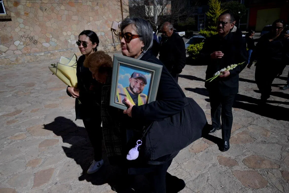 Relatives carry flowers and a framed photo of Ignacio Salazar Flores, one of the miners kidnapped from a mine run by Canada’s Vizsla Silver Corp last month and whose body was found in a clandestine grave in Concordia, Sinaloa, as they arrive at a church for a Mass, in Sombrerete, Zacatecas state, Mexico, February 10, 2026. REUTERS/Edgar Chavez