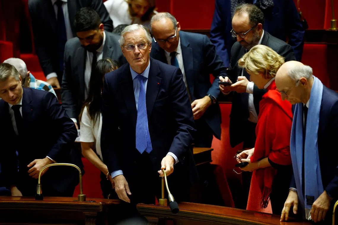French Prime Minister Michel Barnier reacts after the result of the vote on the first motion of no-confidence against the French government, tabled by the alliance of left-wing parties the \"Nouveau Front Populaire\" (New Popular Front - NFP), after the use by French government of the article 49.3, a special clause in the French Constitution, to push the budget bill through the National Assembly without a vote by lawmakers, at the National Assembly in Paris, France, December 4, 2024. REUTERS/Sarah Meyssonnier