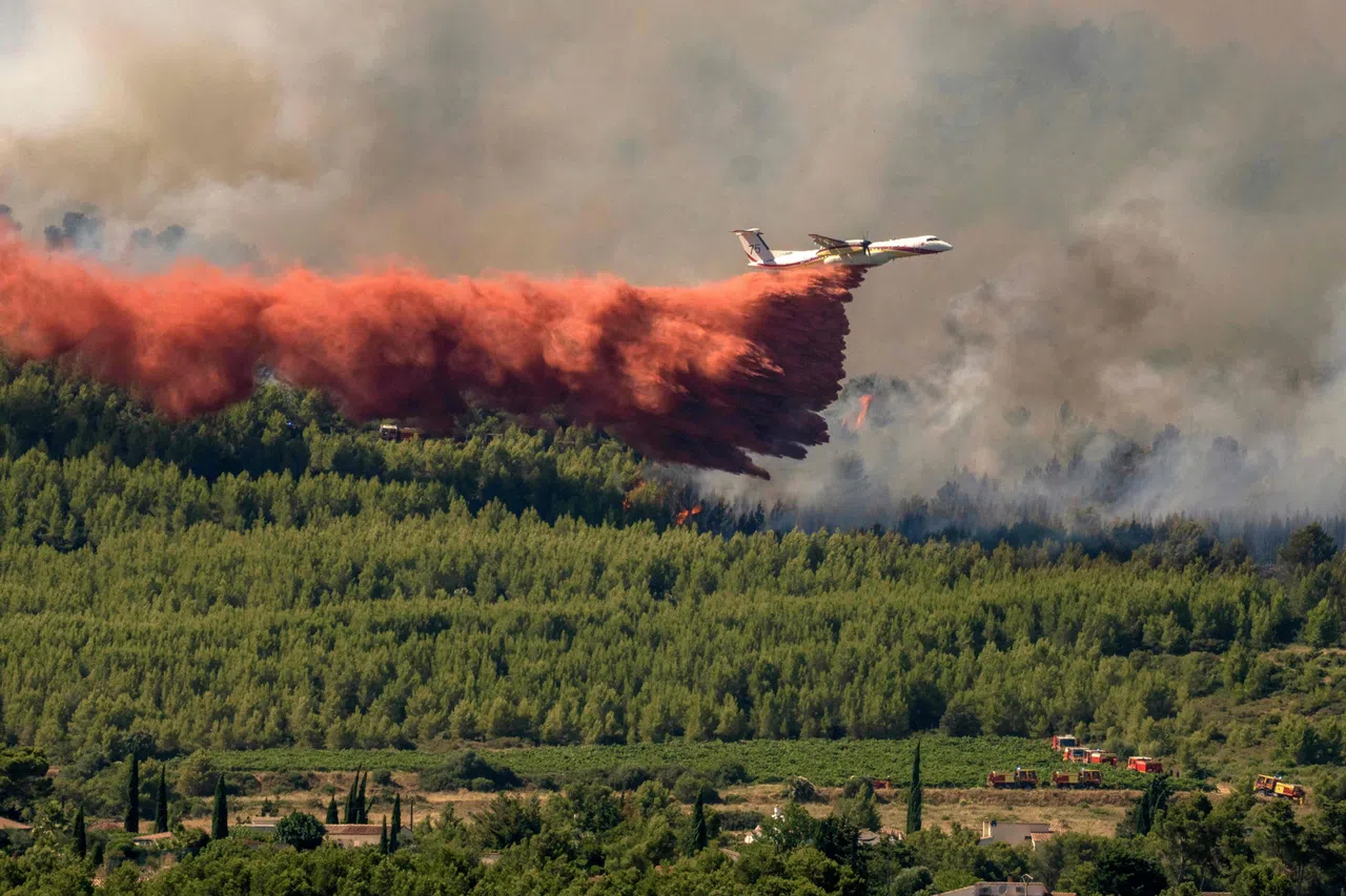 A French civil security aircraft dropping retardant over a wildfire in Pouzols-Minervois, southwestern France,  on July 2.