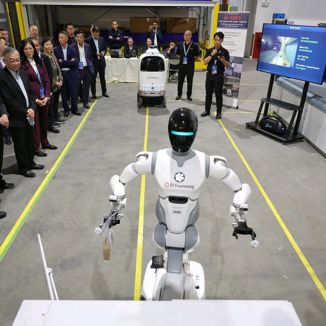 Deputy Prime Minister and Minister for Trade and Industry (Trade) Gan Kim Yong (fourth from left) watching a demonstration at the opening ceremony of ST Engineering’s Changi Creek facility on Oct 9.