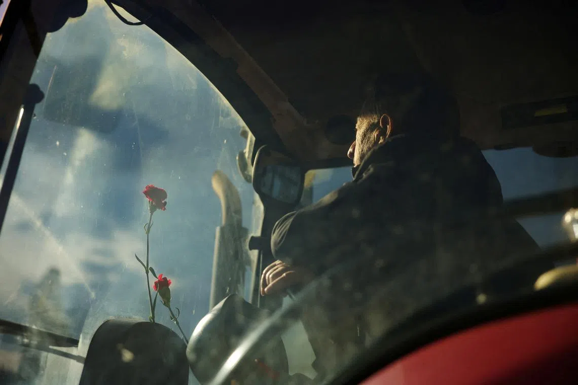 A Greek farmer sitting inside a tractor during a protest by Greek farmers over rising energy costs and competition from imports, in Athens, Greece, Feb 20, 2024. 