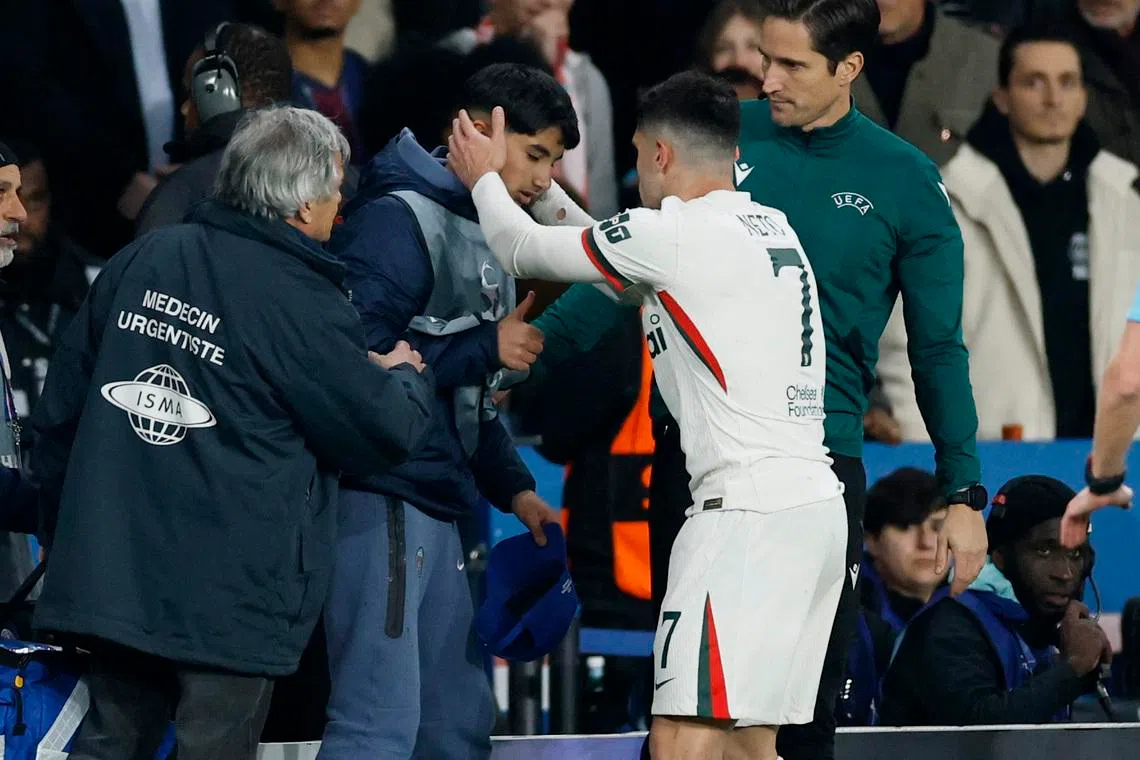 Soccer Football - UEFA Champions League - Round of 16 - First Leg - Paris St Germain v Chelsea - Parc des Princes, Paris, France - March 11, 2026 Chelsea's Pedro Neto checks on ball boy after falling into him Action Images via Reuters/Peter Cziborra