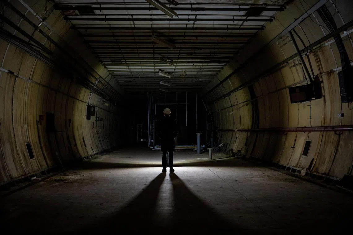A journalist stands, as members of the press are shown around underground tunnels used during World War Two as shelters during the Blitz that are now due to be developed into a new tourist attraction called The London Tunnels, in London, Britain, January 29, 2025. REUTERS/Chris J. Ratcliffe