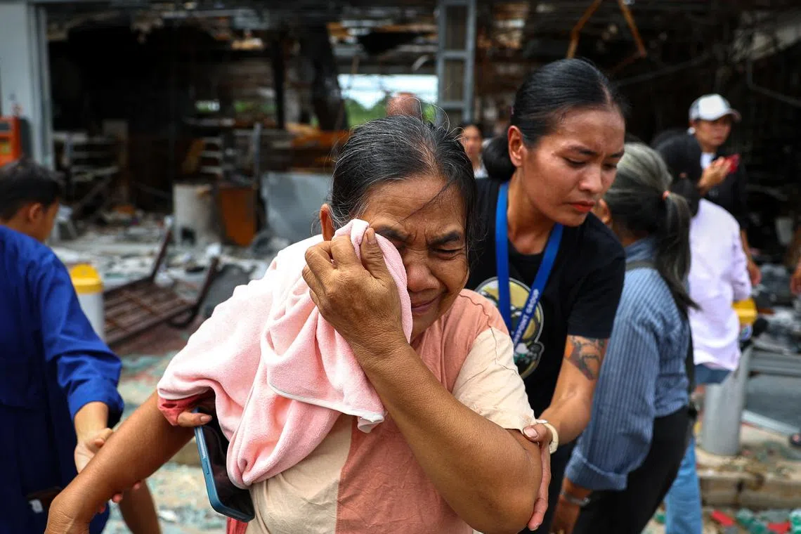 A relative of people who lost their lives when a Cambodian artillery shell slammed into a gas station and destroyed the attached 7-Eleven convenience store, cries after a religious ceremony in Sisaket province, Thailand, July 30, 2025. REUTERS/Athit Perawongmetha
