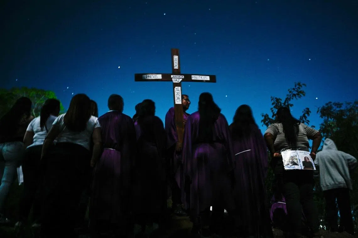 Catholic faithful and relatives of political prisoners taking part in a procession outside El Rodeo prison during Holy Week in Guatire, Miranda state, Venezuela on April 1, 2026. 