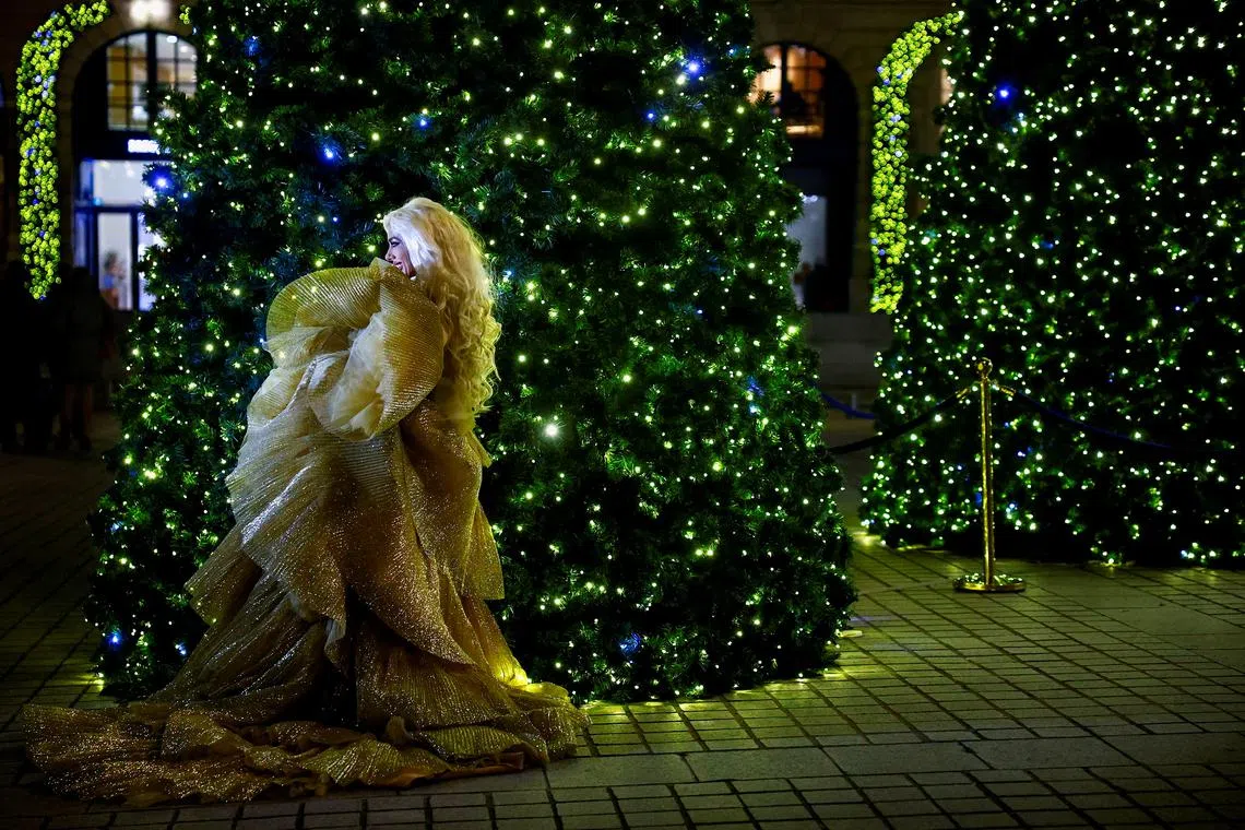 A model posing in front of decorations for the Christmas season at Place Vendome in Paris, France, on Dec 11, 2024. 