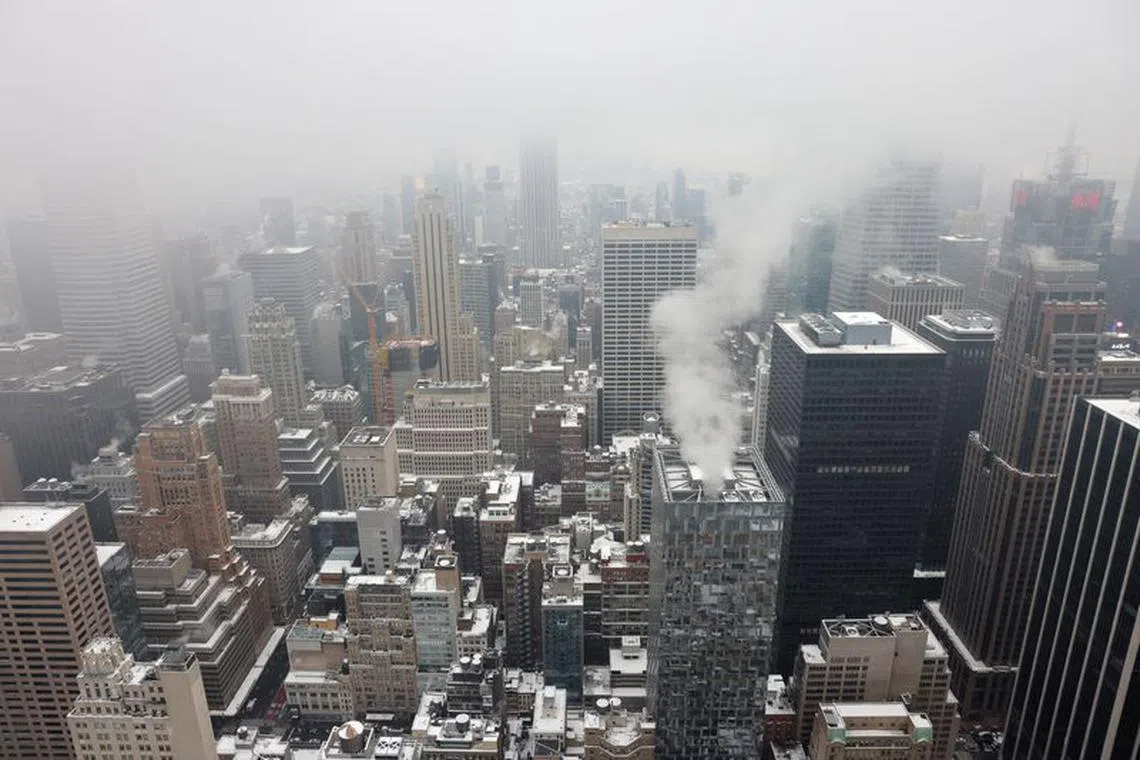 Snow sits on rooftops during the first snowfall in over 700 days in Manhattan, New York City, U.S., January 16, 2024. REUTERS/Andrew Kelly