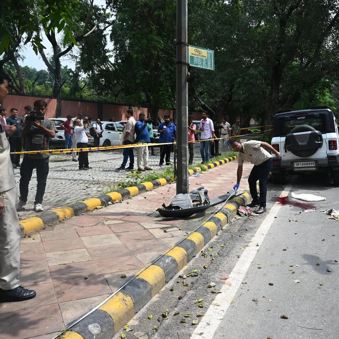 A forensic team examines the spot at Mother Teresa Crescent Marg at Talkatora Parking, where a Thar met with an accident, in New Delhi, on Aug 10, 2025.