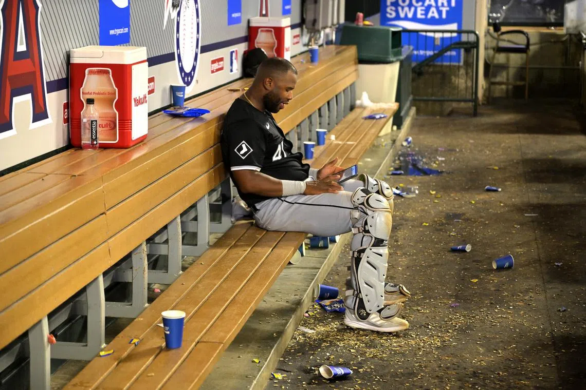 Sep 16, 2024; Anaheim, California, USA; Chicago White Sox catcher Chuckie Robinson (47) sits in an empty dugout reviewing his batting on an iPad after the game against the Los Angeles Angels at Angel Stadium. Jayne Kamin-Oncea-Imagn Images/File Photo