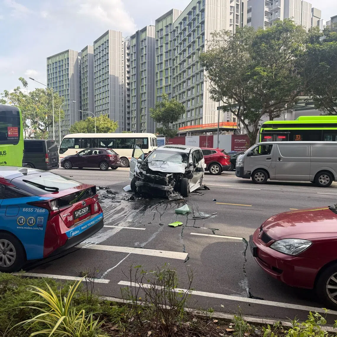 A black car with a damaged bumper and hood was seen on the third lane, with oil and debris surrounding it.