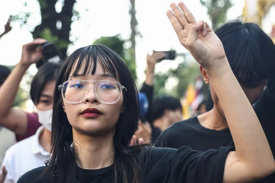 Thai monarchy reform activist Tantawan \"Tawan\" Tuatulanon shows a three-finger salute as she is arrested for sedition and related charges outside a criminal court in Bangkok, Thailand, February 13, 2024. REUTERS/Chalinee Thirasupa