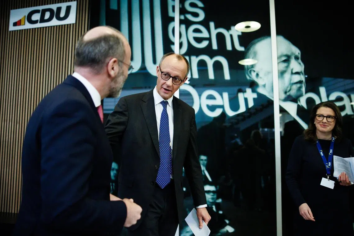 Christian Democratic Union chariman Friedrich Merz (second from left) and European People's Party president Manfred Weber (left) talking after a press conference in Berlin, on Jan 18.