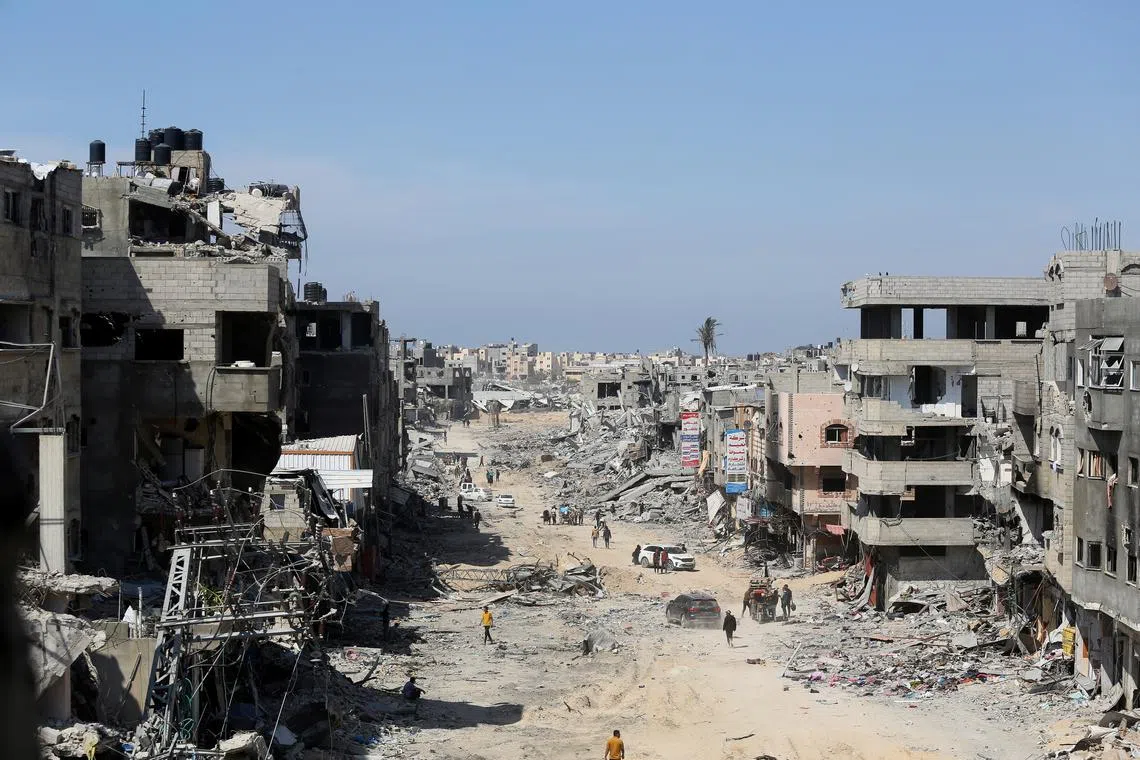 FILE PHOTO: Palestinians inspect destroyed residential buildings, after the Israeli military withdrew most of its ground troops from the southern Gaza Strip, amid the ongoing conflict between Israel and Hamas, in Khan Younis, in the southern Gaza Strip April 7, 2024. REUTERS/Ahmed Zakot/File Photo