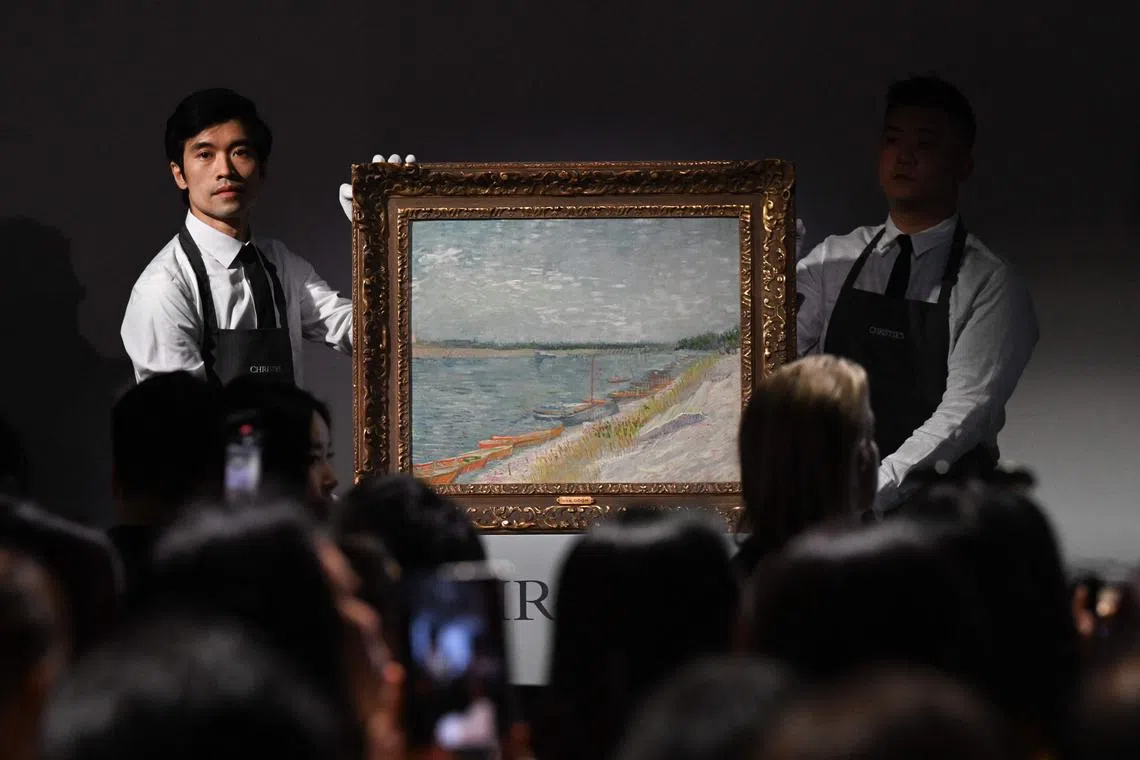 Christie’s staff hold up "Les canots amarrés" by Vincent Van Gogh from 1887, which sold at auction at Christie’s Hong Kong headquarters for HK$215,000,000 (US$27.7million) in Hong Kong on September 26, 2024. (Photo by Peter PARKS / AFP) / RESTRICTED TO EDITORIAL USE - MANDATORY MENTION OF THE ARTIST UPON PUBLICATION - TO ILLUSTRATE THE EVENT AS SPECIFIED IN THE CAPTION