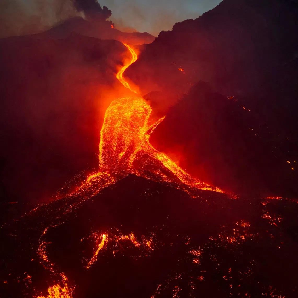 A drone view shows molten lava flowing down the slope  during an eruption at Mount Etna in Sicily, Italy, August 11, 2026.  Giuseppe Di Stefano/Etna Walk/via REUTERS