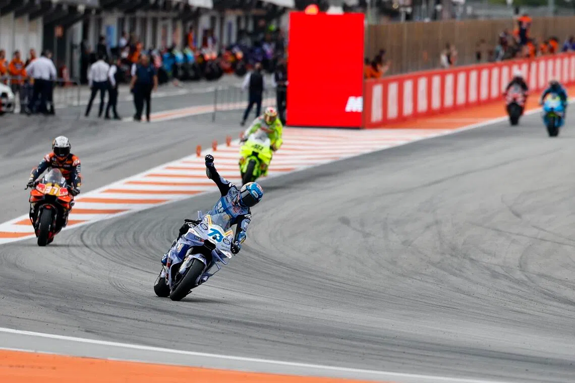 Spanish MotoGP rider Alex Marquez celebrates after winning the sprint race of the motorcyling Grand Prix of the Valencia Community at Ricardo Tormo track, in Cheste, Spain on Nov 15, 2025.