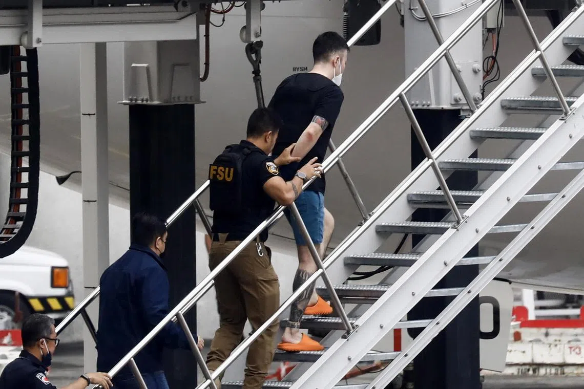 epa10451806 Japanese deportee Fujita Toshiya (top) is escorted by authorities into an airplane bound for Japan at the international airport of Manila, Philippines, 07 February 2023. Tokyo sought the deportation of four Japanese nationals detained in Manila who allegedly remotely coordinated a series of robberies in Japan.  EPA-EFE/ROLEX DELA PENA
