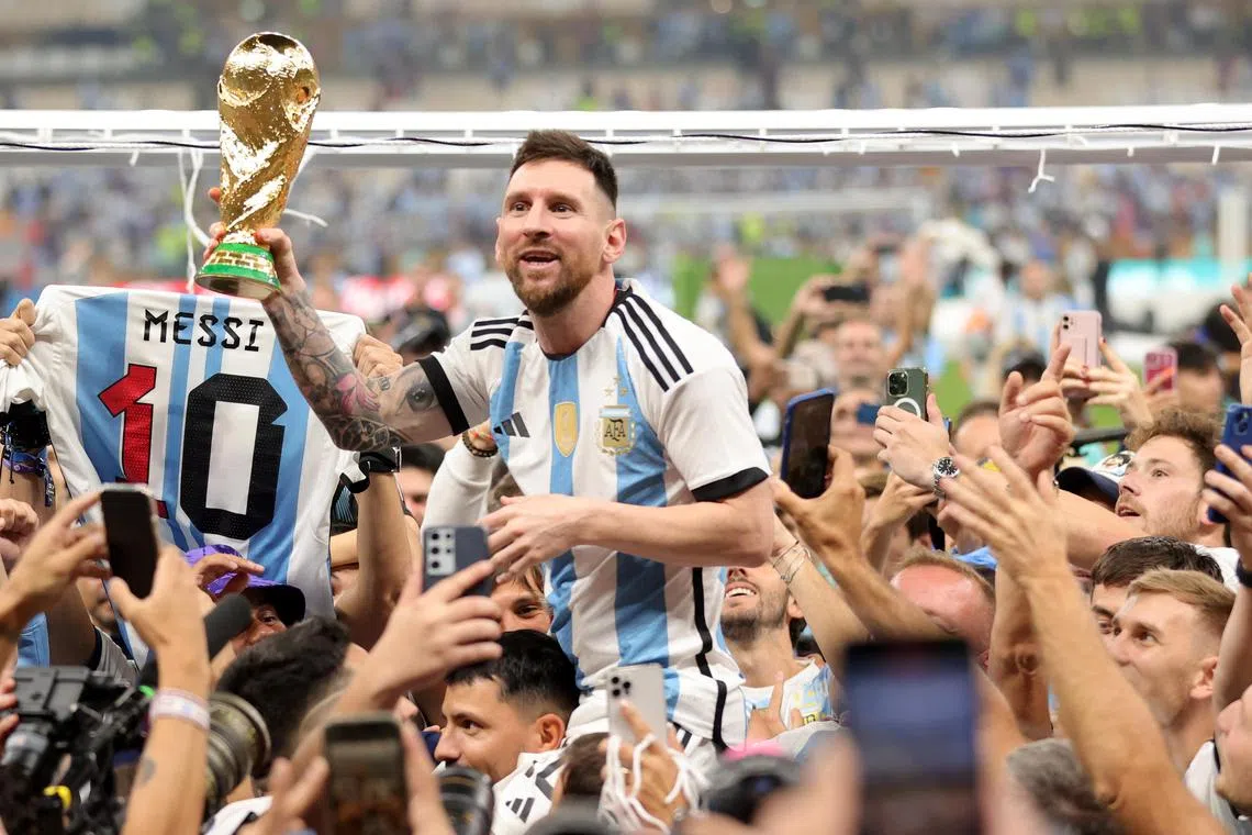 Lionel Messi lifting the World Cup trophy after Argentina defeated France 4-2 on penalties in the final on Sunday