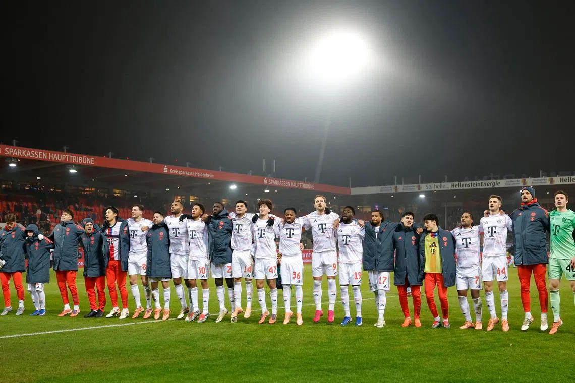 Soccer Football - Bundesliga - 1. FC Heidenheim v Bayern Munich - Voith-Arena, Heidenheim, Germany - December 21, 2025 Bayern Munich players celebrate after the match REUTERS/Heiko Becker