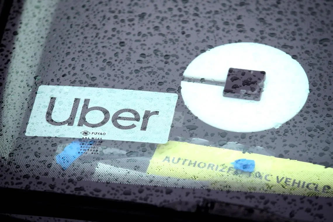 The Uber logo is displayed on a car in San Francisco, California, on March 22, 2019. Dutch regulator hits Uber with 290-mn-euro fine over driver data transfer. (Photo by JUSTIN SULLIVAN / GETTY IMAGES NORTH AMERICA / AFP)