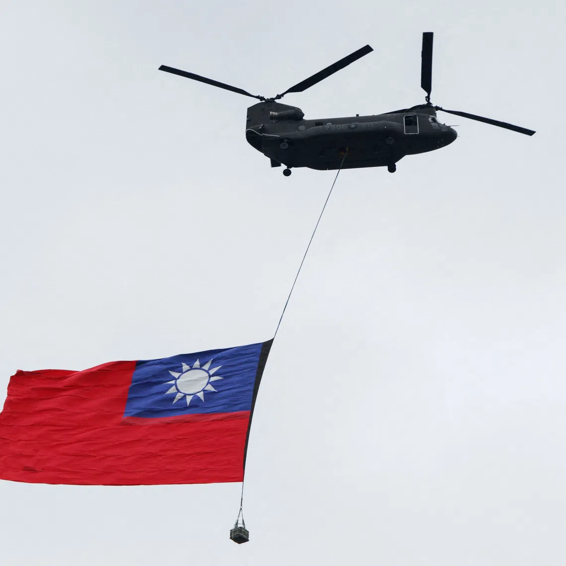 A US-made Chinook helicopter flies with a giant Taiwanese flag during a rehearsal ahead of Taiwan’s National Day celebrations in Taipei on Oct 6.
