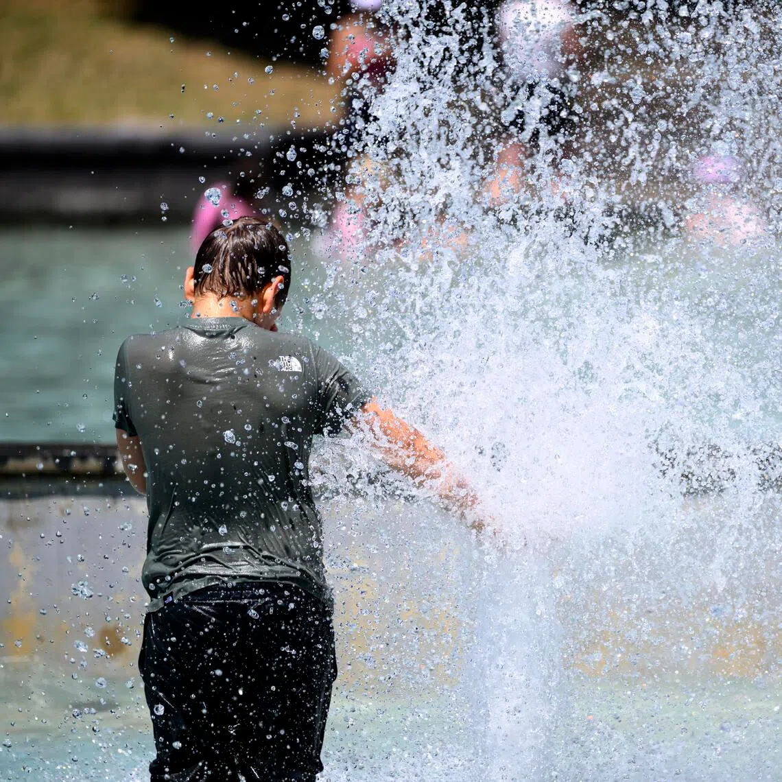 epa13058501 Children cool off by playing in the water of the public fountain in Milan Park during a heat wave in Lausanne, Switzerland, 23 June 2026. A heat wave is hitting Switzerland and is expected to last at least until 29 June. The Federal Office of Meteorology and Climatology (MeteoSwiss) has raised the heat warning in most of the country from a level 3 to a level 4 alert.  EPA/LAURENT GILLIERON
