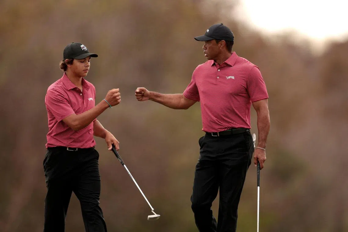 Tiger Woods and his son Charlie Woods reacting on the 16th green during the second round of the PNC Championship at Ritz-Carlton Golf Club on Dec 22.