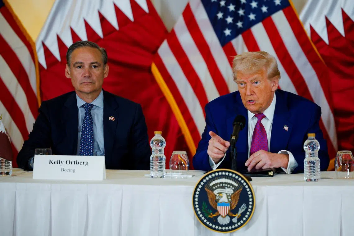 US President Donald Trump and President and CEO of Boeing Kelly Ortberg attend a roundtable discussion in Doha, Qatar, in May.