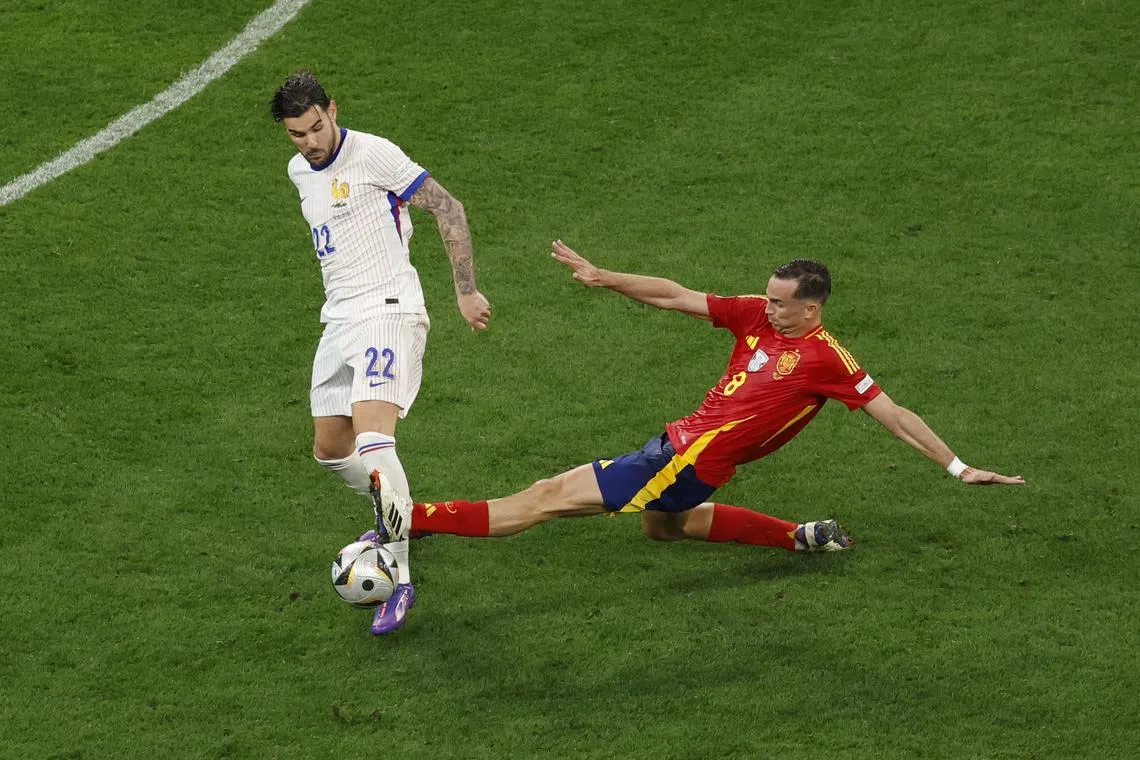 Soccer Football - Euro 2024 - Semi Final - Spain v France - Munich Football Arena, Munich, Germany - July 9, 2024 France's Theo Hernandez in action with Spain's Fabian Ruiz REUTERS/Heiko Becker/ File Photo