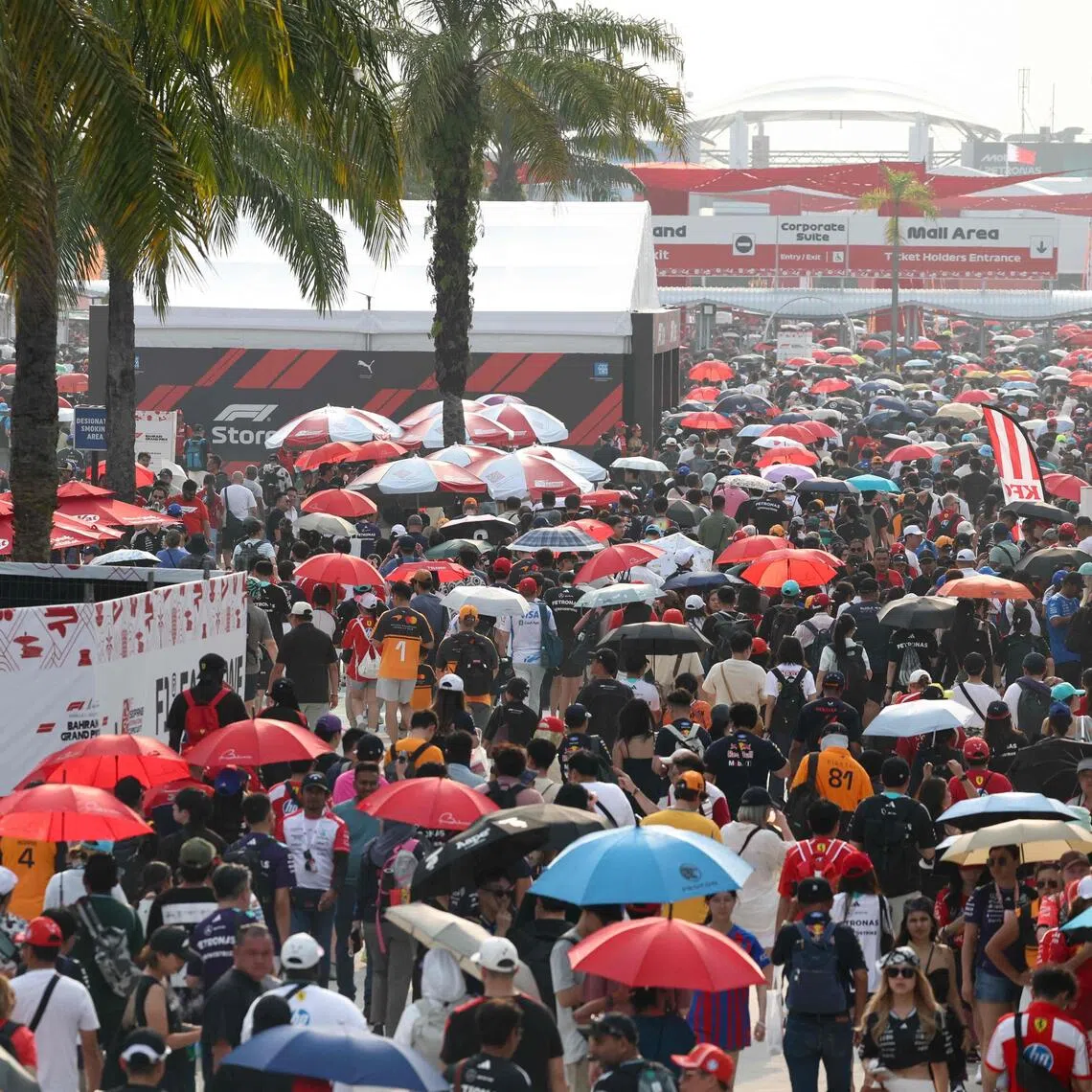 Fans leave the venue after the qualifying session of the Formula One Bahrain Grand Prix in Sepang on Oct 3.