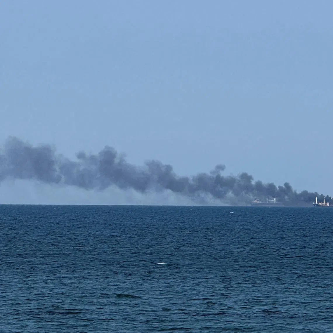 Smoke rises from a civilian vessel on fire, amid Russia's attack on Ukraine, in Odesa, Ukraine July 19, 2026.Picture taken with a mobile phone. REUTERS/Stringer