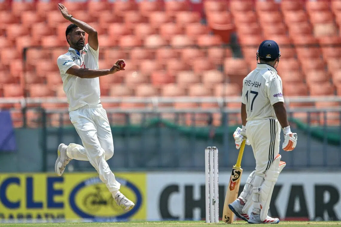 Afghanistan's Mohammad Saleem bowls as India's Rishabh Pant watches on the second day of their only cricket Test at the Maharaja Yadavindra Singh International Cricket Stadium on the outskirts of Chandigarh on June 7, 2026.