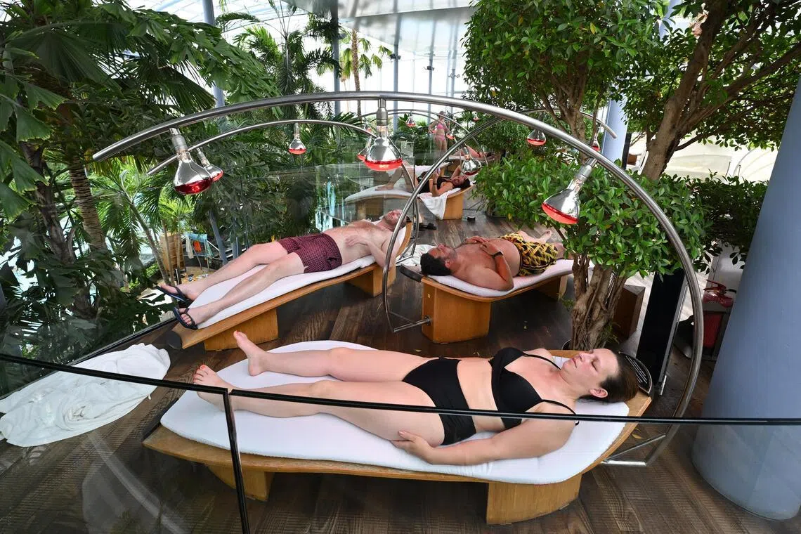 Beds lit by infrared lamps are scattered throughout the Bucharest facility.