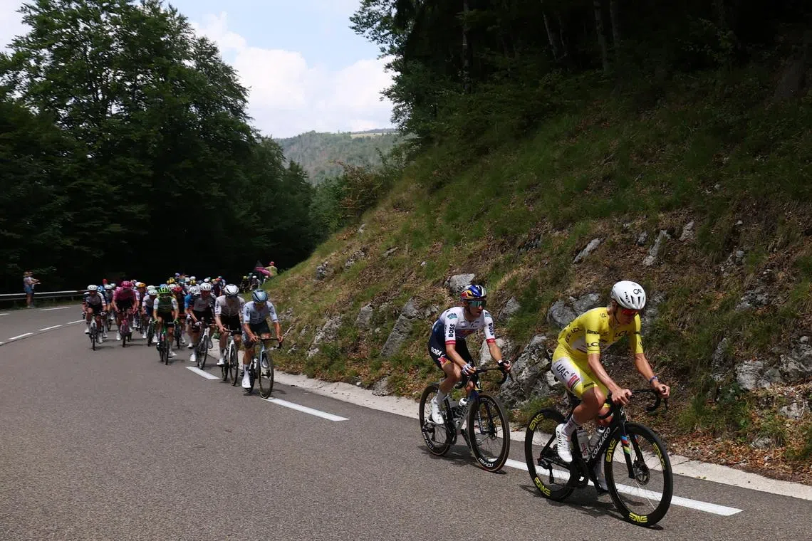 Cycling - Tour de France - Stage 15 - Champagnole to Plateau de Solaison - Champagnole, France - July 19, 2026 UAE Team Emirates - XRG's Tadej Pogacar wearing the yellow jersey in action with other cyclists during stage 15 REUTERS/Gonzalo Fuentes