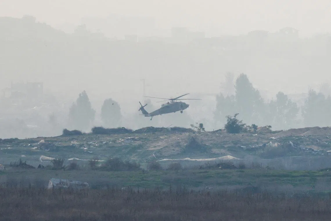 An Israeli Black Hawk military helicopter landing inside North Gaza, amid an ongoing conflict between Israel and Hamas, as seen from Israel, on Jan 14, 2025. REUTERS/Amir Cohen     TPX IMAGES OF THE DAY