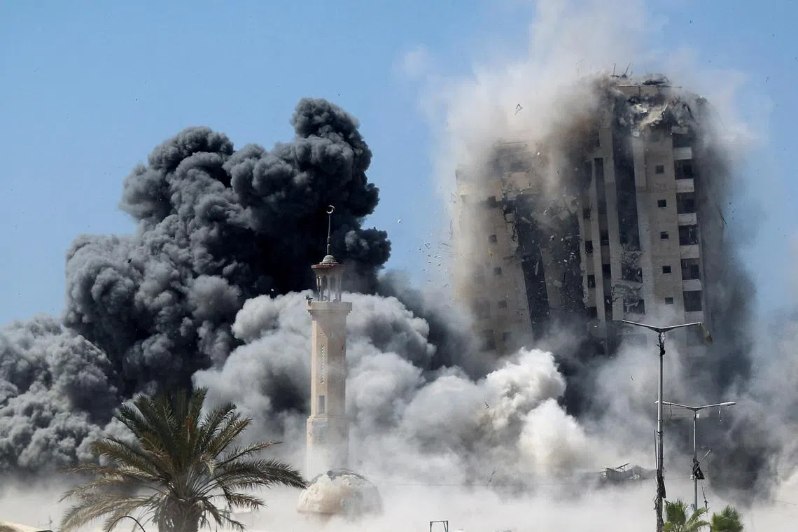 Smoke rises as a building hit by an Israeli air strike collapses, in Gaza City, Sept 5.