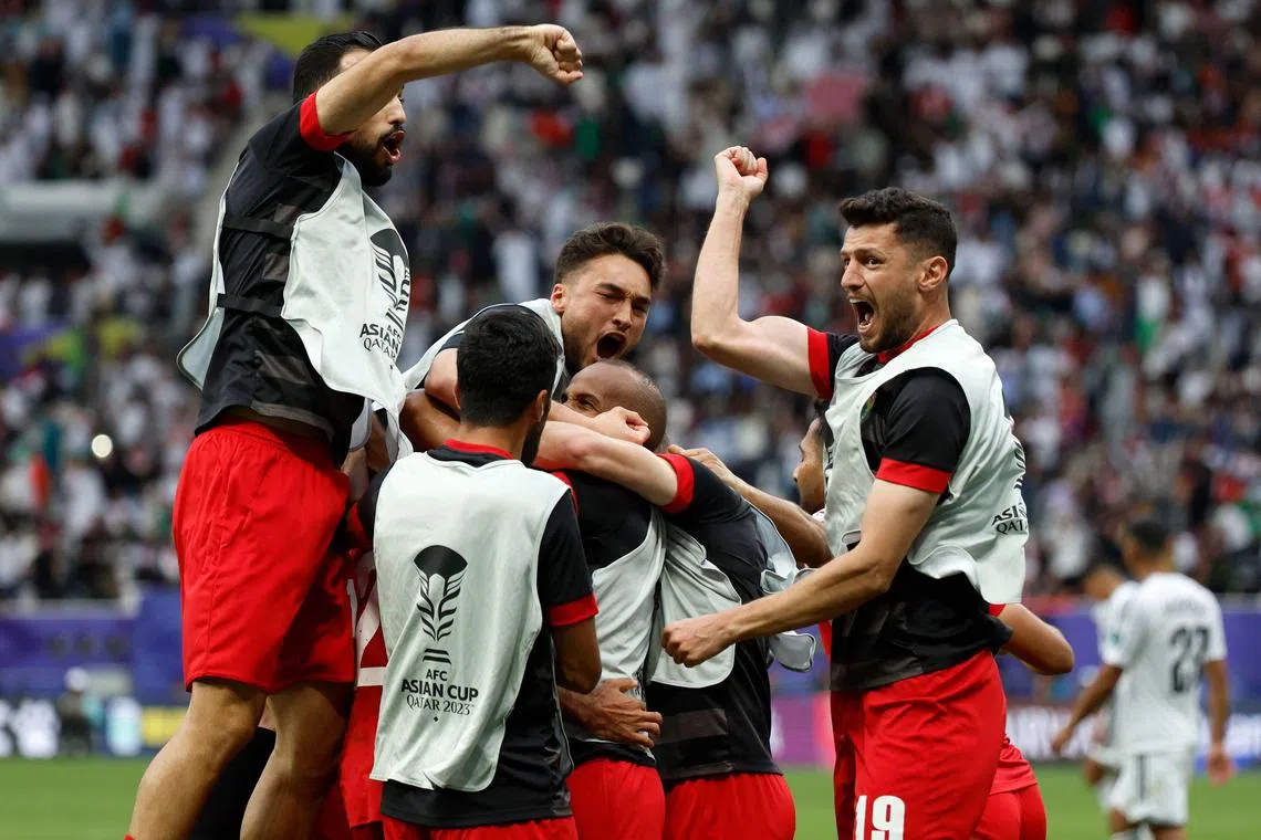 Jordan's players celebrating their 3-2 win at the Qatar 2023 Asian Cup football match between Iraq and Jordan at Khalifa International Stadium in Doha on Jan 29.