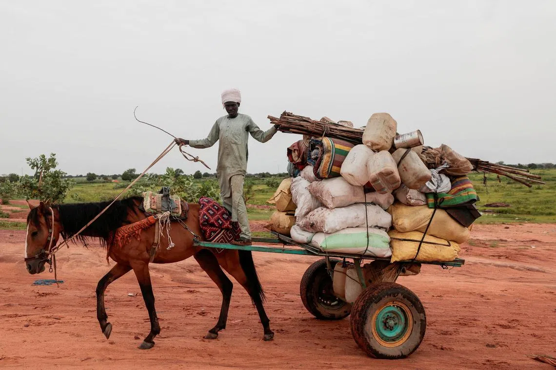 FILE PHOTO: A Chadian cart owner transports belongings of Sudanese people who fled the conflict in Sudan's Darfur region, while crossing the border between Sudan and Chad in Adre, Chad August 4, 2023. REUTERS/Zohra Bensemra/File Photo