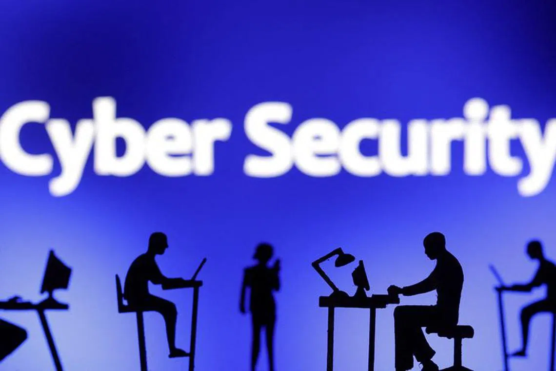 Figurines with computers and smartphones are seen in front of the words \"Cyber Security\" in this illustration taken, February 19, 2024. REUTERS/Dado Ruvic/Illustration