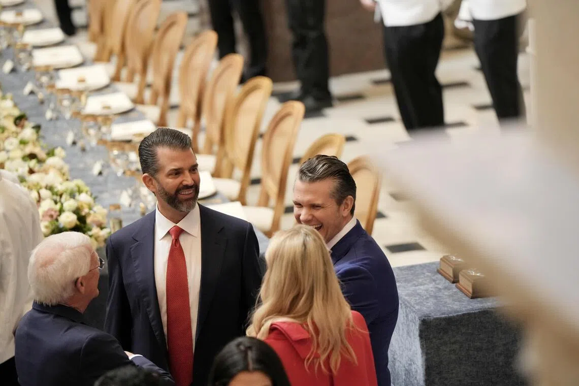 US President Donald Trump's son, Mr Donald Trump Jr. (left) chats with Secretary of Defence Pete Hegseth (right), and others on Jan 20.