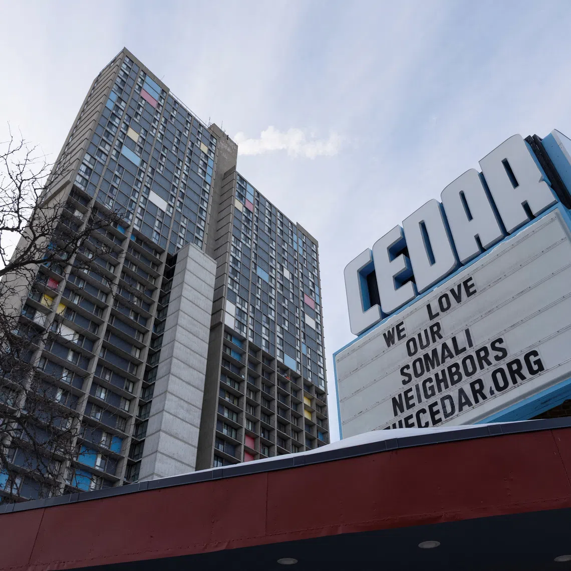 A sign reading \"We love our Somali neighbors\" lines a marquee in the Cedar-Riverside neighborhood amid reports of a federal immigration operation targeting the Somali community in Minneapolis, Minnesota, U.S. December 4, 2025.  REUTERS/Tim Evans