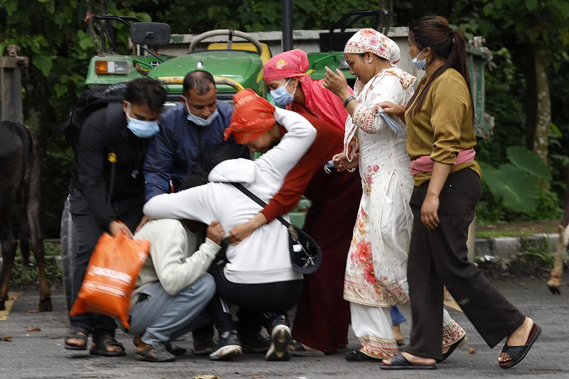 Relatives of a flash flood victim mourning during a funeral in Nepal’s Chitwan district on Aug 31.