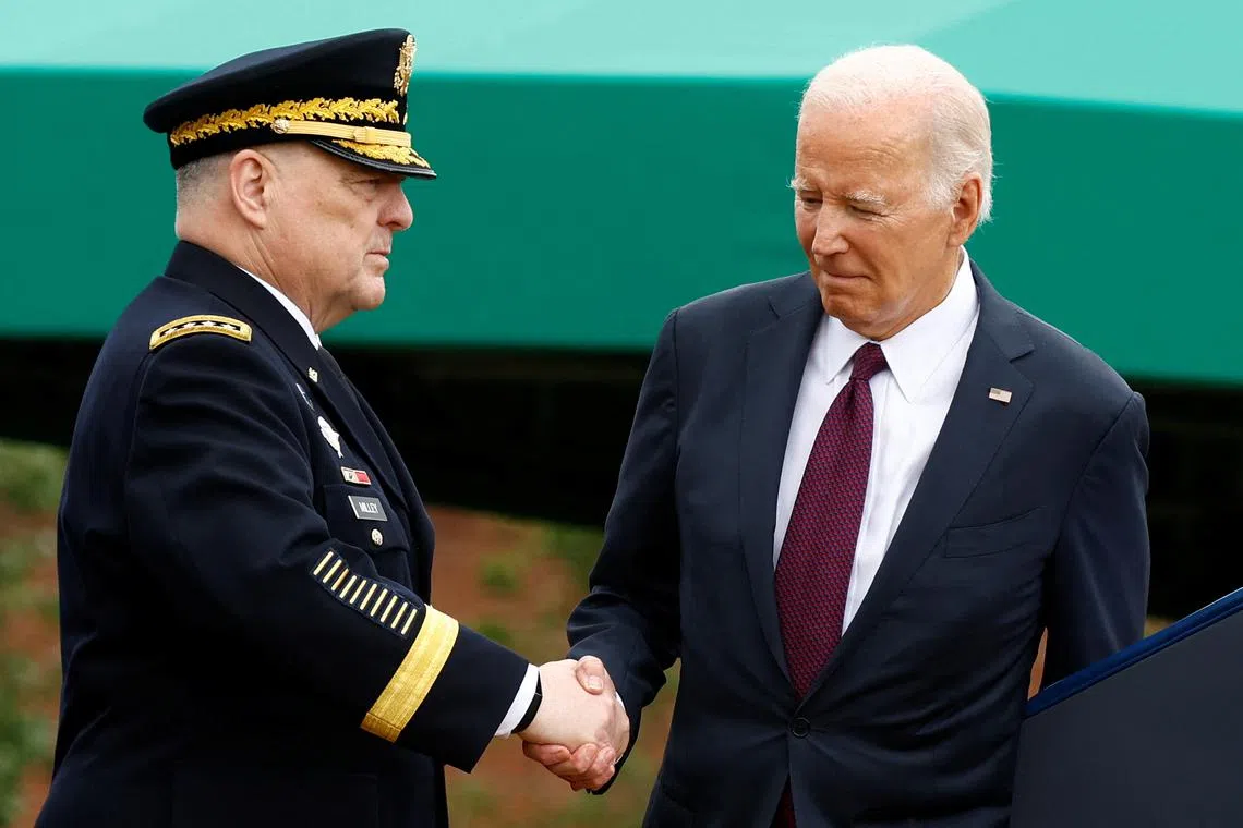 FILE PHOTO: U.S. President Joe Biden shakes hands with General Mark A. Milley, 20th Chairman of the Joint Chiefs of Staff during the Armed Forces Farewell Tribute in his honor and Armed Forces Hail in honor of General Charles Q. Brown, Jr., the 21st Chairman of the Joint Chiefs of Staff at Summerall Field at Joint Base Myer-Henderson Hall, Arlington, Virginia, U.S., September 29, 2023. REUTERS/Evelyn Hockstein