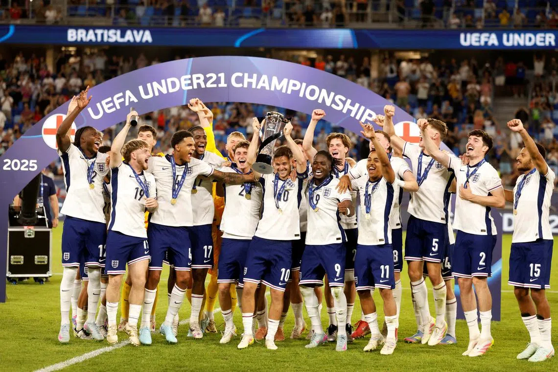 Soccer Football - UEFA Under 21 Championship - Final - England v Germany - Tehelne pole, Bratislava, Slovakia - June 28, 2025 England's James McAtee lifts the trophy as they celebrate after winning the final REUTERS/David W Cerny