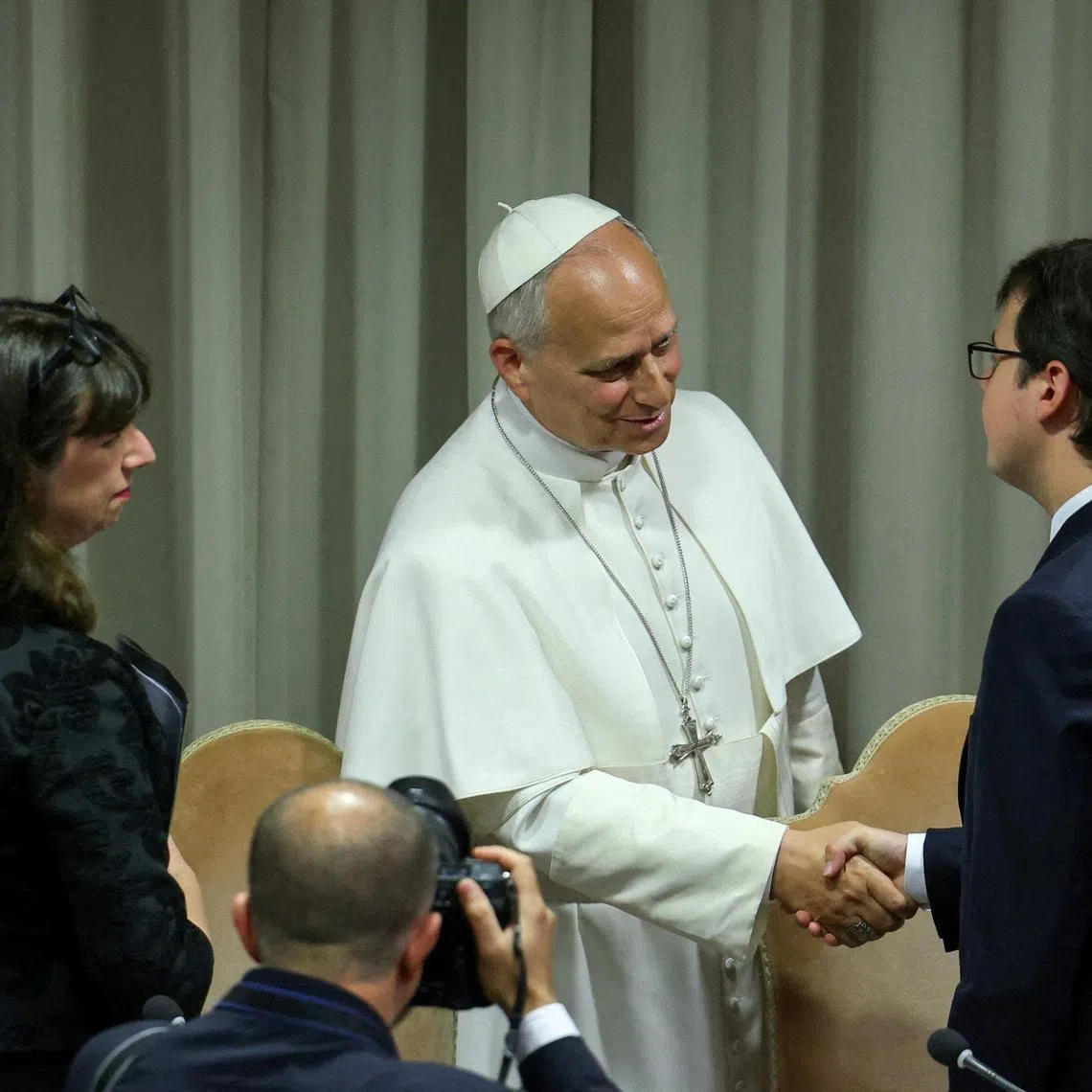 Pope Leo XIV (centre) shaking hands with Anthropic co-founder Christopher Olah (right) at the presentation of "Magnifica humanitas", his first encyclical, on May 25.