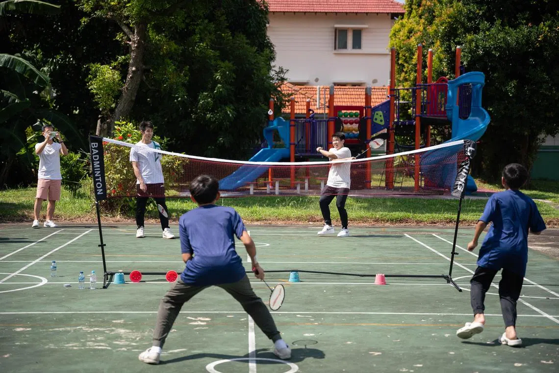 dlbad08 - Loh Kean Yew and Loh Kean Hean playing badminton with the children at the Pertapis Children's Home on 8 July 2023. 

Credit: Brian Teo