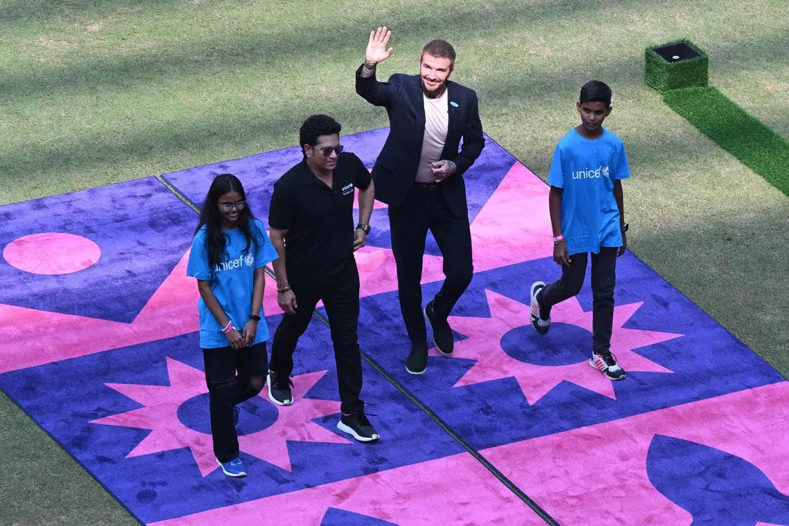 David Beckham, along with India's former cricket player Sachin Tendulkar, waves towards his fans before the start of the Cricket World Cup semi-final between India and New Zealand.