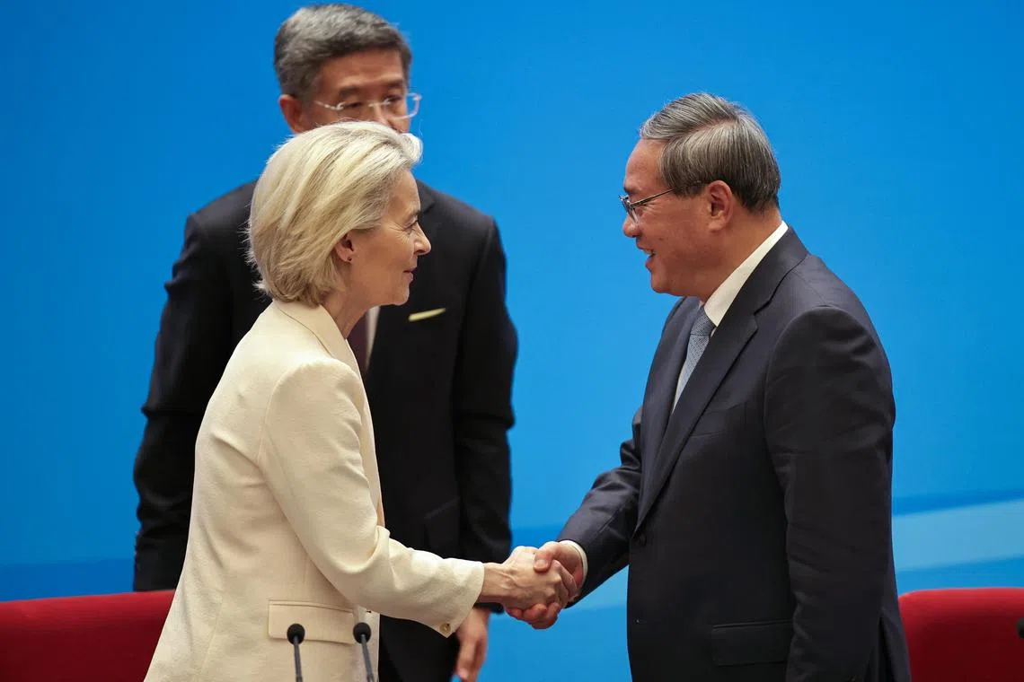 Chinese Premier Li Qiang shakes hands with European Commission President Ursula von der Leyen at the end of the EU-China Business leaders symposium at the Great Hall of the People in Beijing, on July 24, 2025.