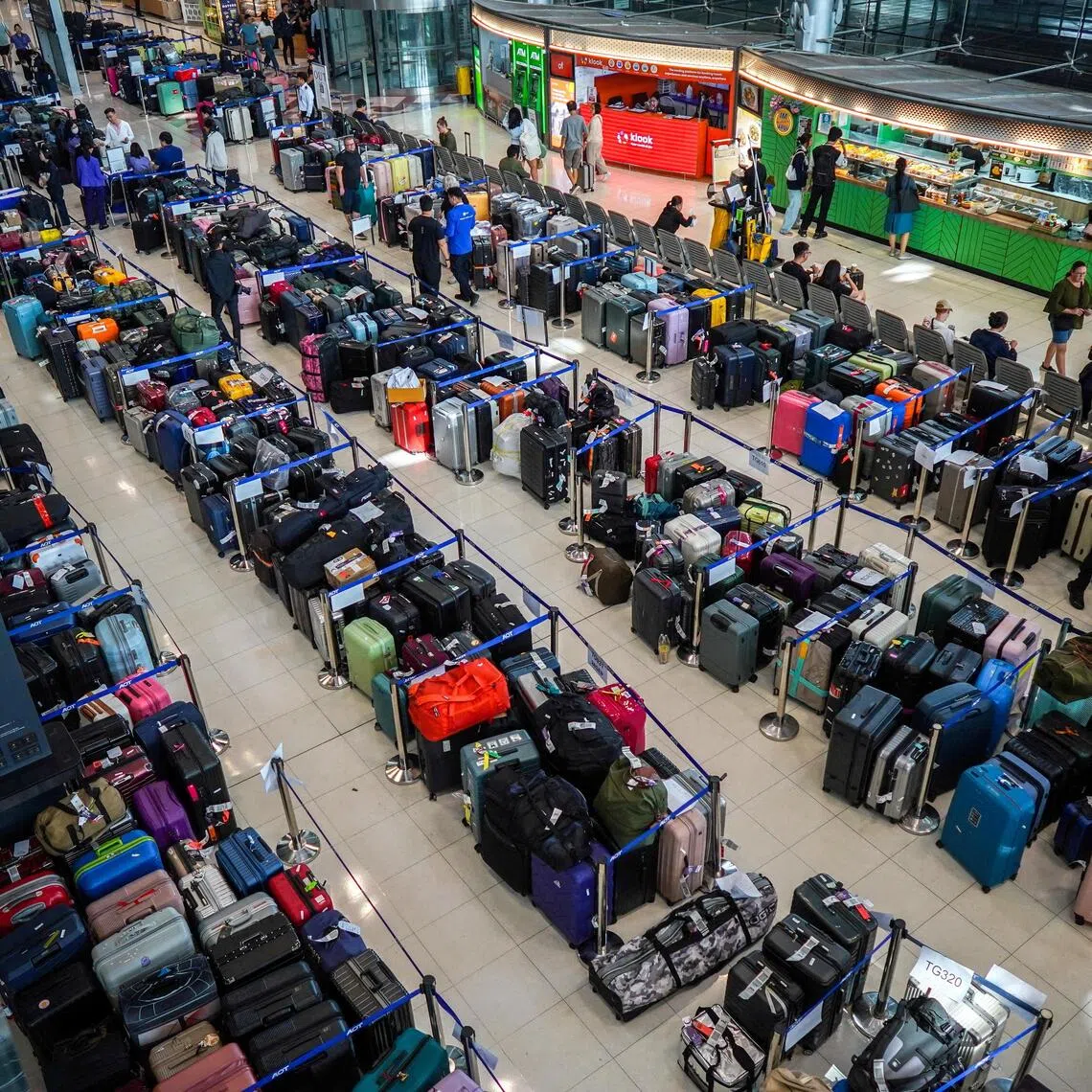 Rows of luggage have spilled into the arrivals area at Suvarnabhumi Airport as passengers search for missing bags.