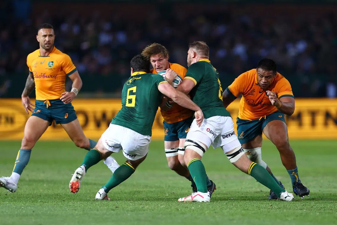 Rugby Union - Rugby Championship - South Africa v Australia - Loftus Versfeld, Pretoria, South Africa - July 8, 2023 Australia's Michael Hooper in action with South Africa's Marco van Staden and Duane Vermeulen REUTERS/Siphiwe Sibeko/File Photo